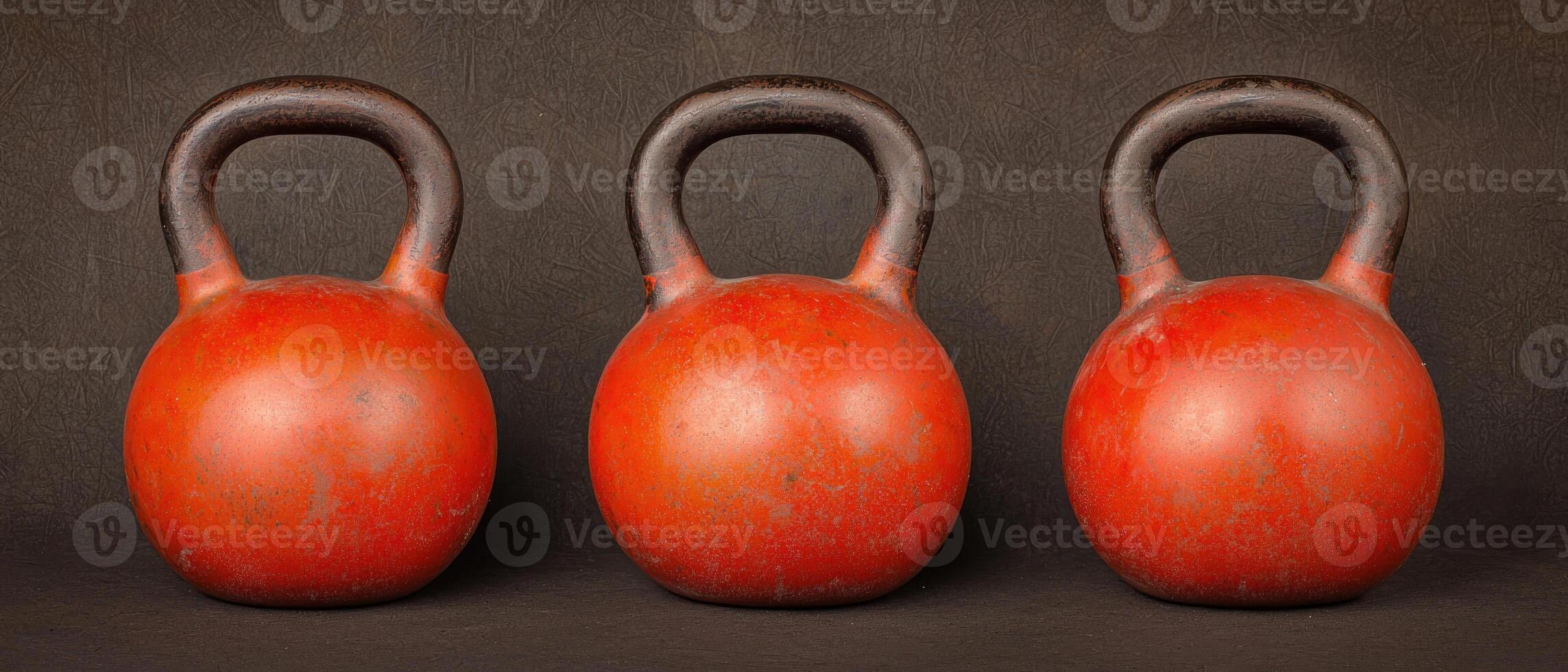 Set of three vibrant kettlebells on a dark background for fitness enthusiasts. photo
