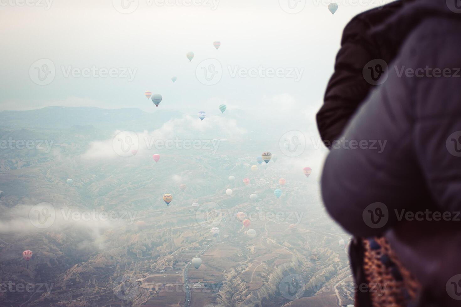 hot air balloon take off passengers enjoy kapadokya valleys views inside hot air balloon basket in winter. Cappadocia hot air balloon flight attraction photo