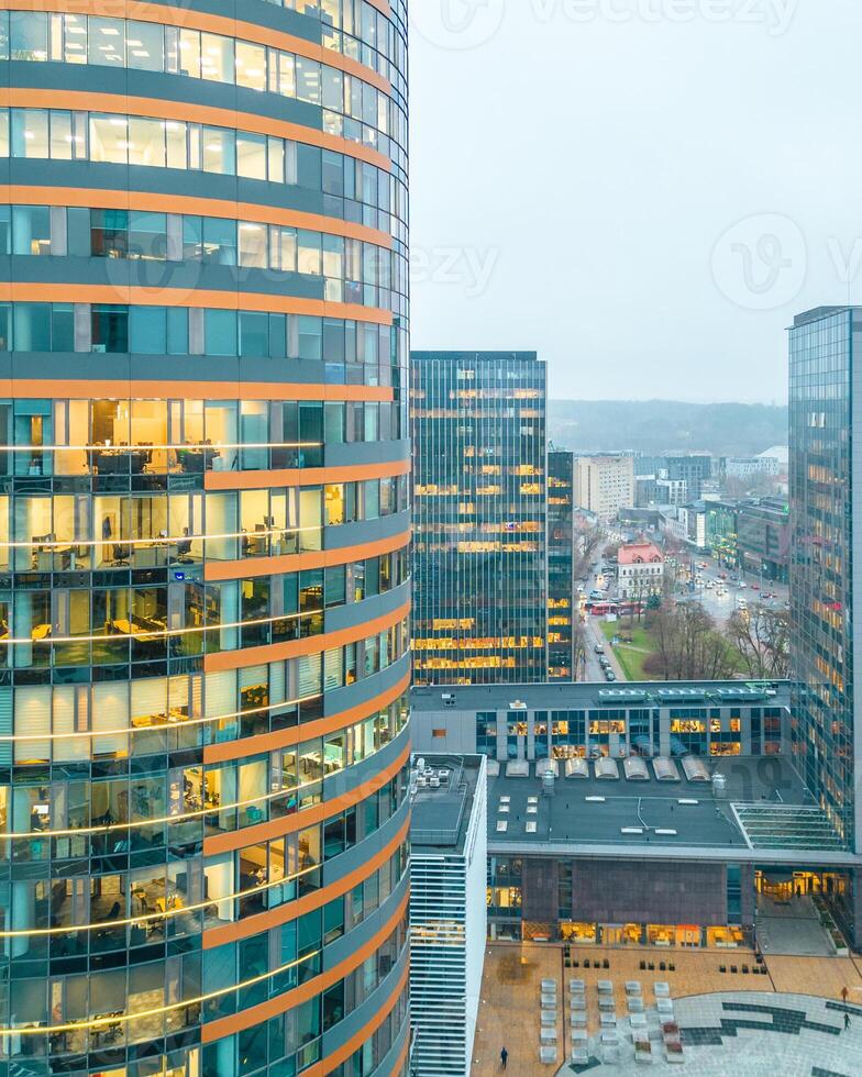 employees workers in office in The Europa Tower is a high-rise located in Vilnius CBD, Lithuania. It is the tallest building in the Baltic states. photo