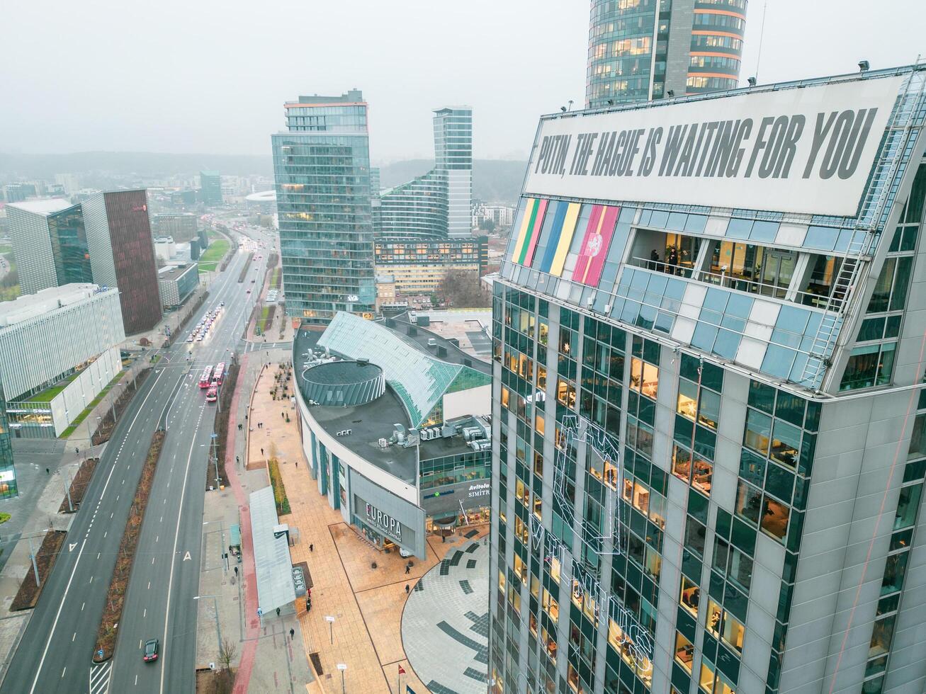 Vilnius, Lithuania - 28th november, 2024- giant billboard on skyscraper with sign, - Putin Hague is waiting for you. Russia occupant aggressor country concept. Economical sanctions for Russian photo