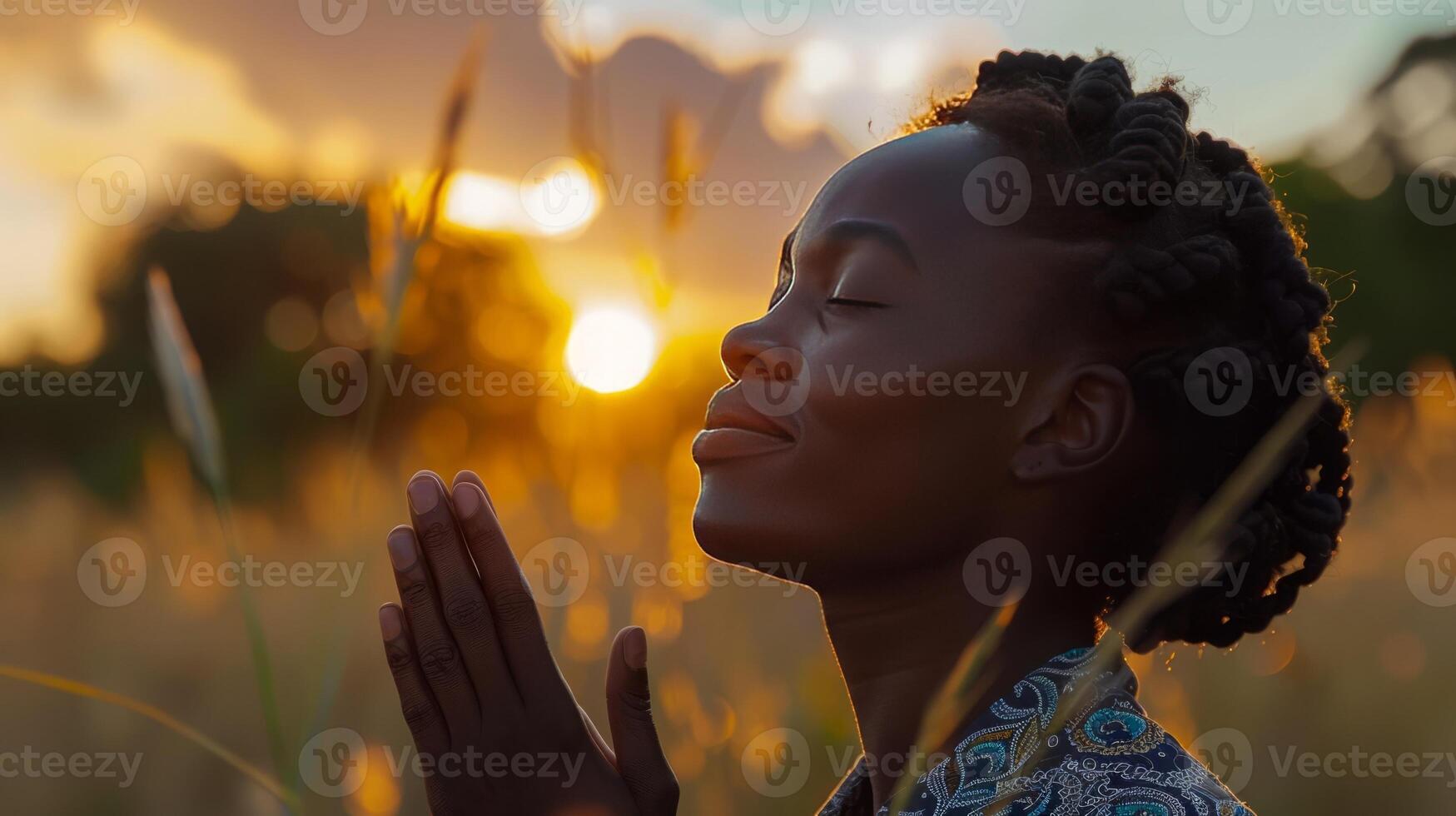 A beautiful african woman praying to God photo