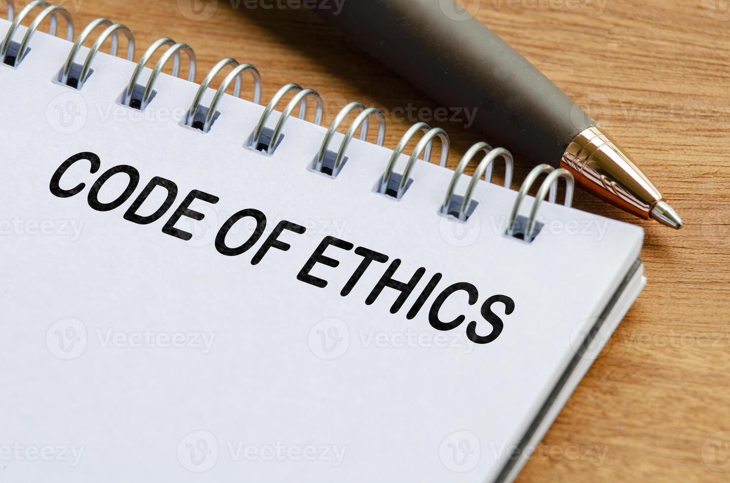 Code of ethics text on white notepad. Business code of ethics concept photo