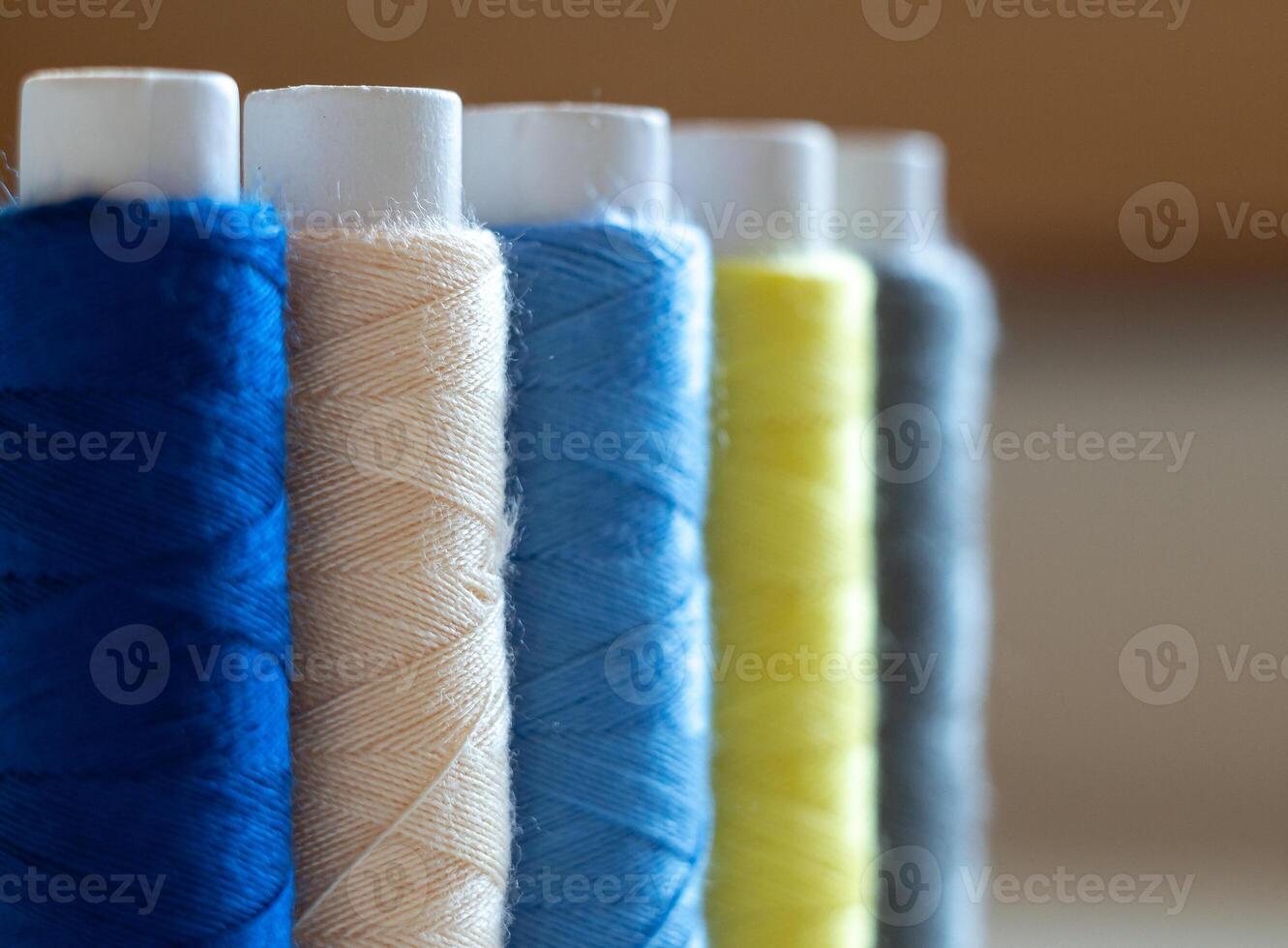 macro photography of multi-colored skeins of thread for sewing. photo