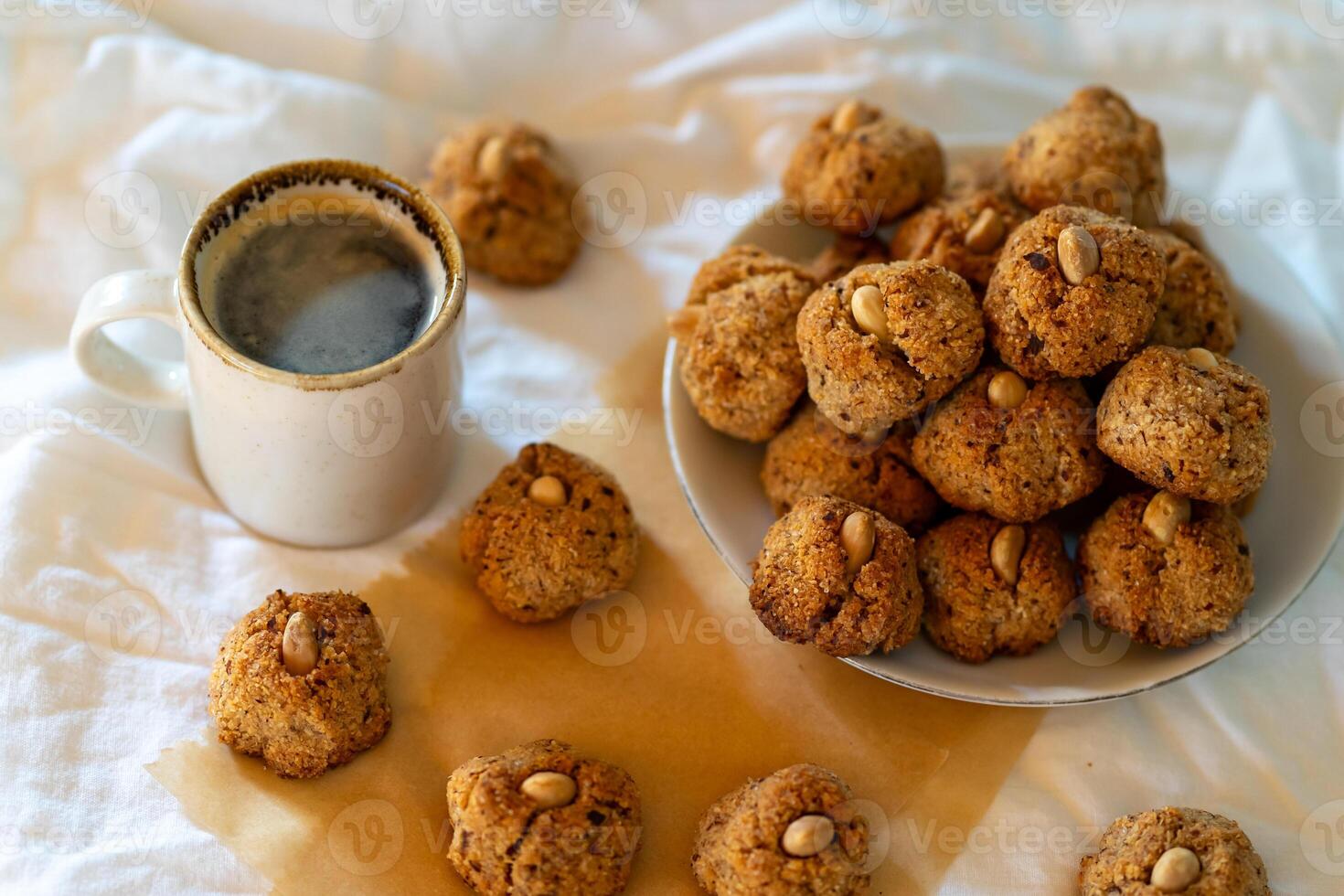 Lots of small nut cookies with whole almonds in the middle. photo