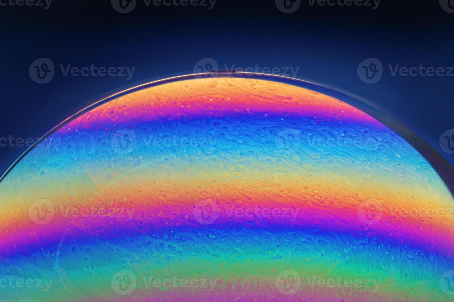 Macro Closeup of a Soap Bubble on a Dark Blue Background photo