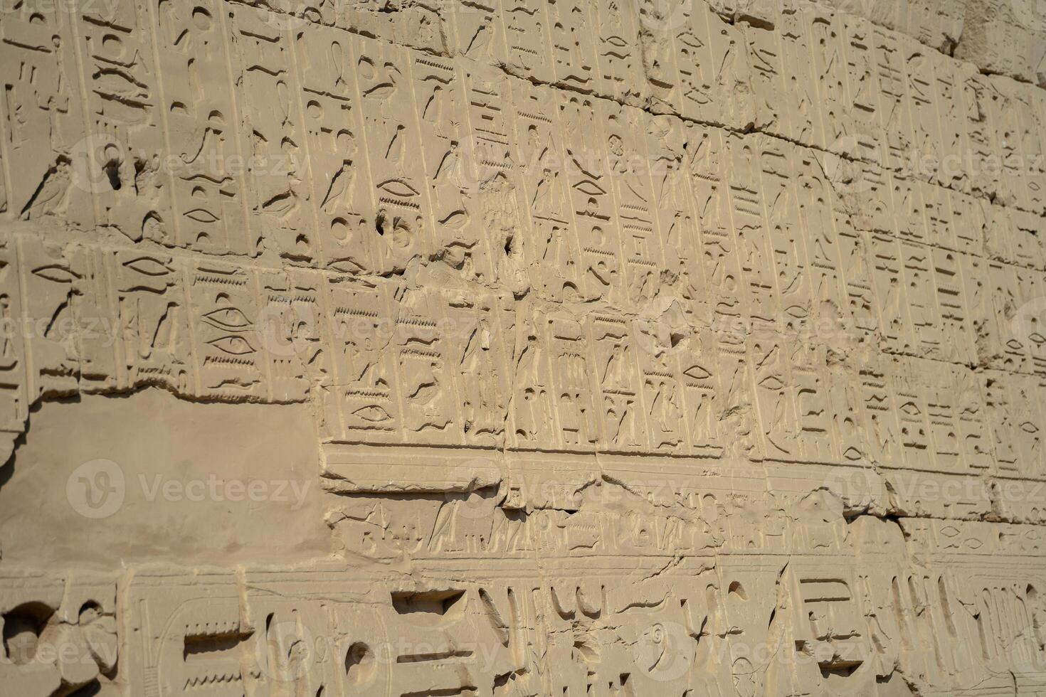 Ancient Egyptian ancient wall with carved hieroglyphs in Luxor photo