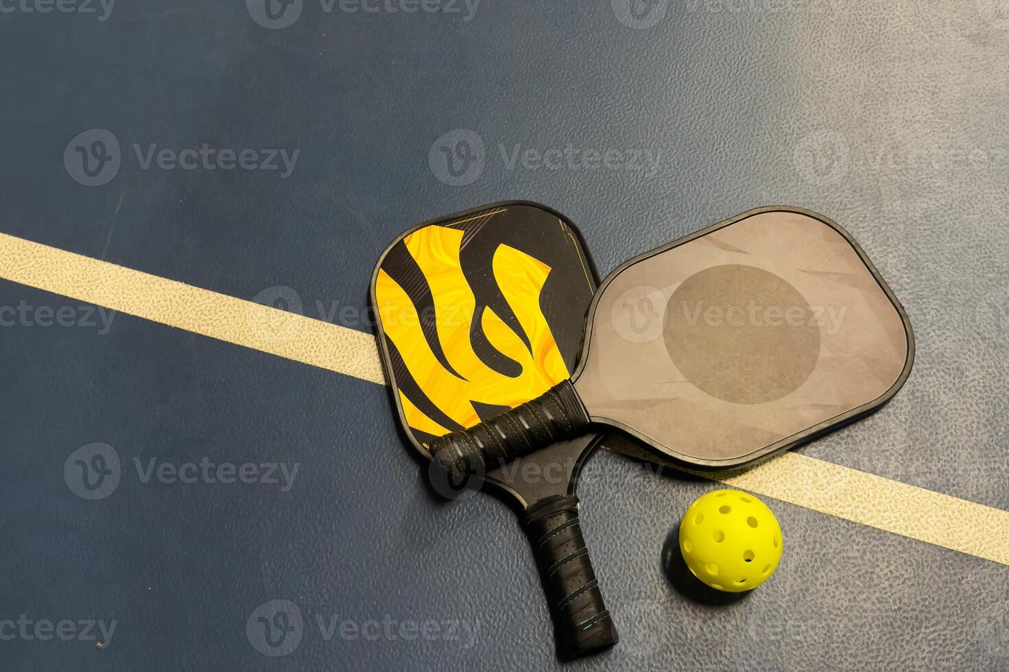 Pickleball tennis racket on the court. Blue background with copy space. Sport court and ball. photo