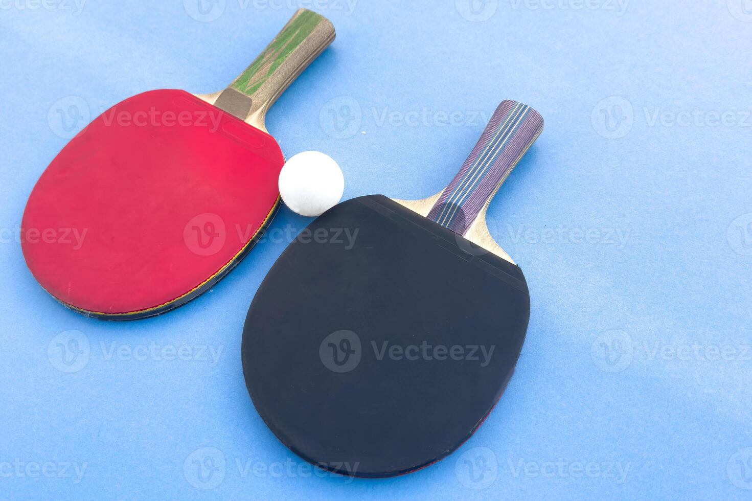 tennis rackets for playing ping pong on blue table, ping pong concept, active sports photo