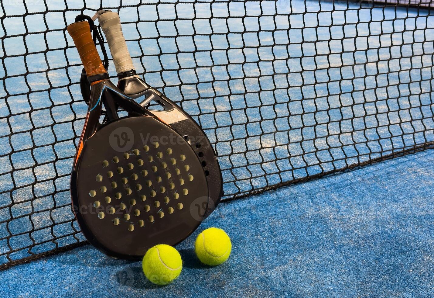 Padel tennis racket. Background with copy space. Sport court and balls. photo