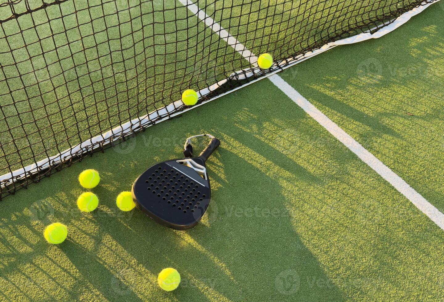 Background of padel racket and ball on artificial grass floor in outdoor court. Top view. photo