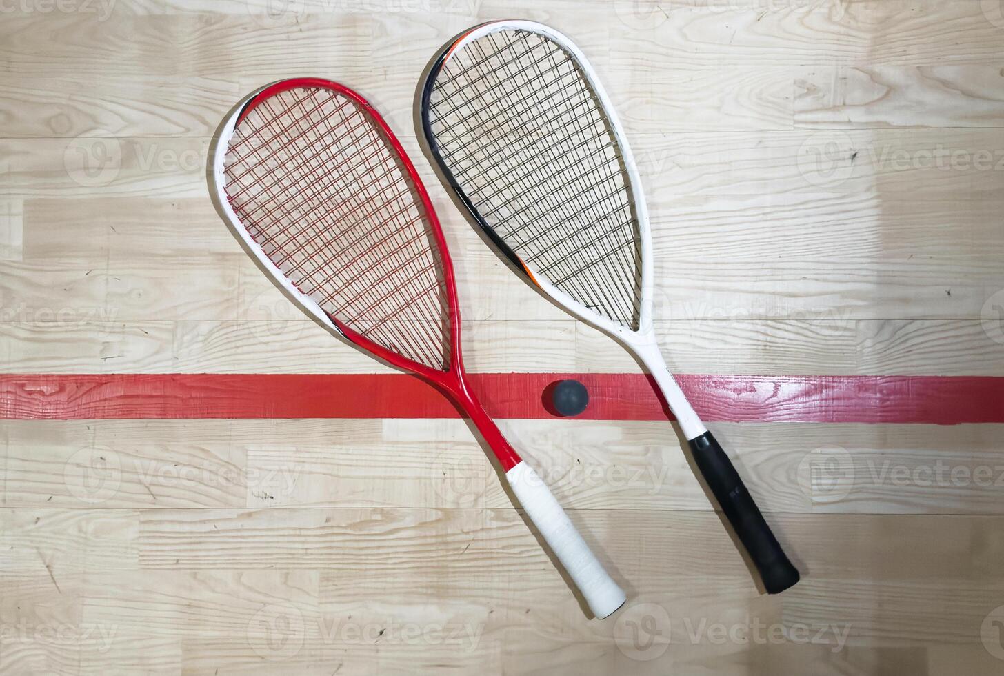 Empty squash court and rackets on the wooden floor. photo