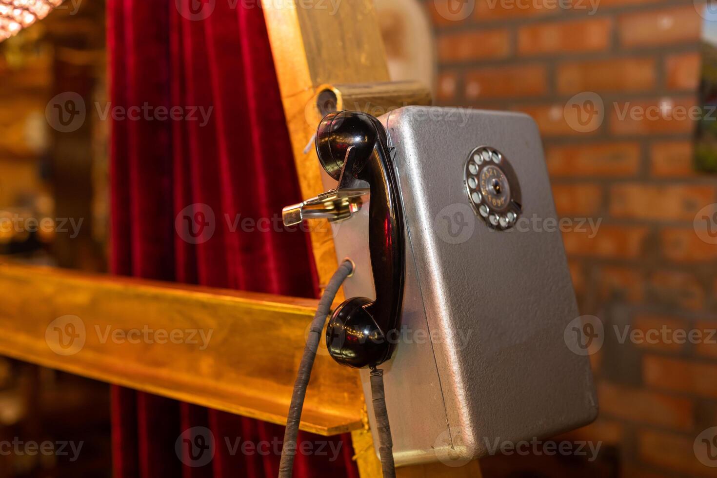 the old grey payphone with spot for phone receiver closeup photo