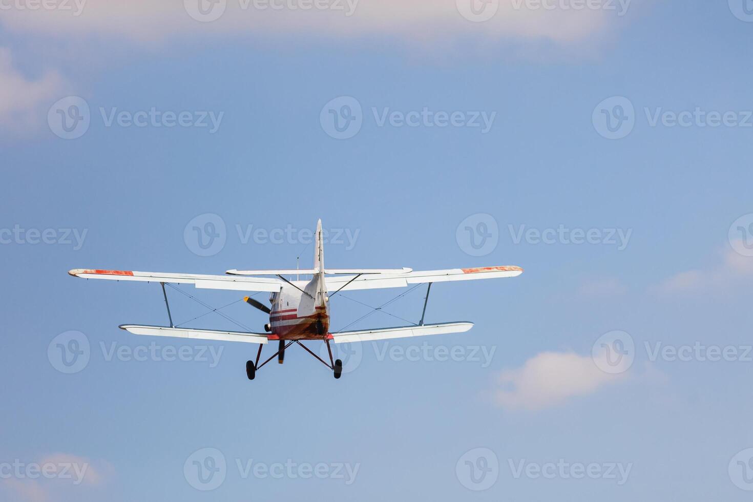 Small airplane against blue sky photo