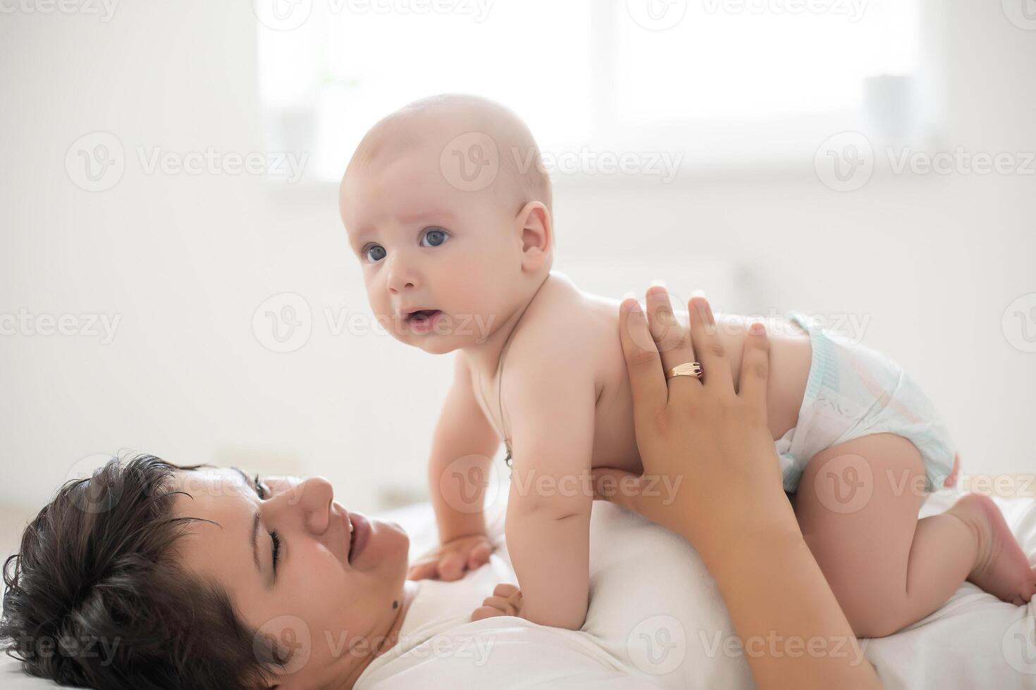 picture of happy mother with baby in hands photo