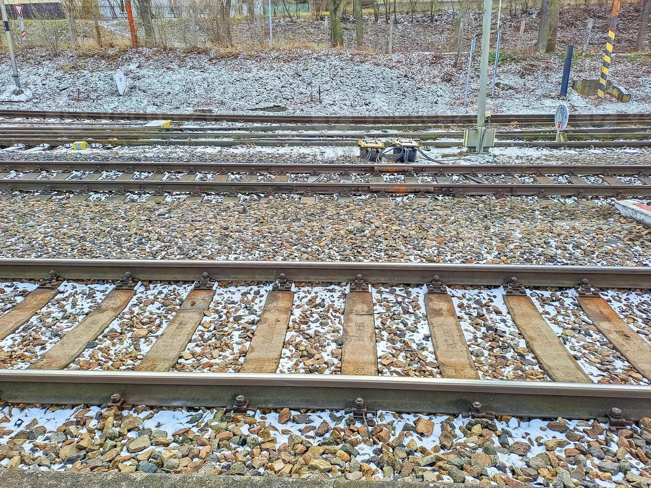 Winter landscape with snow covered rails on a road railway in a snowy scene photo