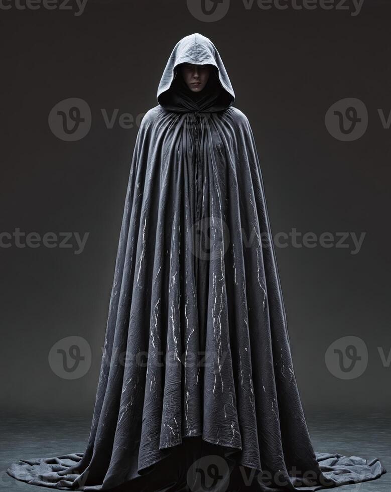 Mysterious Cloaked Figure in a Dark Background with Intriguing Textures photo