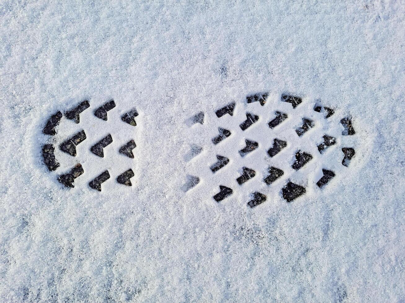 Footprints in fresh snow. Natural background with snow texture., copyspace. photo