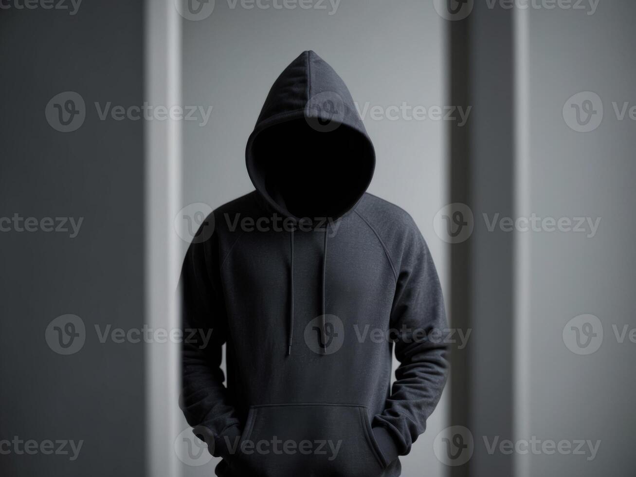 Mysterious figure in a hooded sweatshirt with an obscured face.Mysterious figure in a hooded sweatshirt with an obscured face. photo