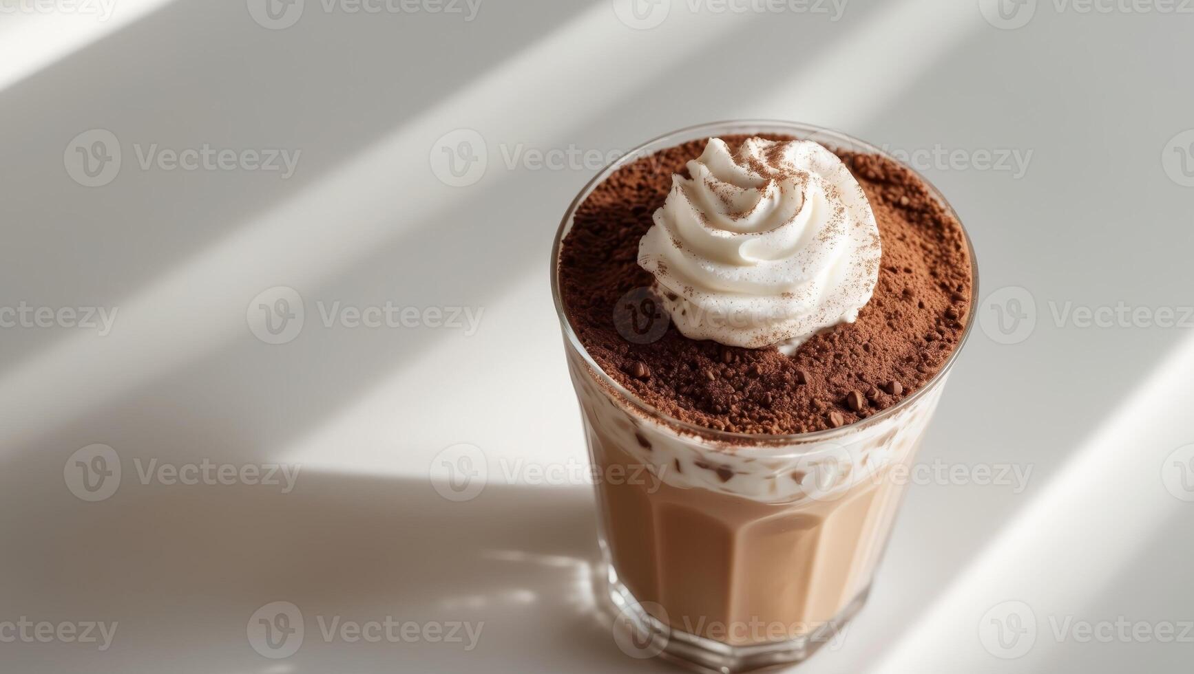 Iced coffee drink layered with cocoa powder topping photo