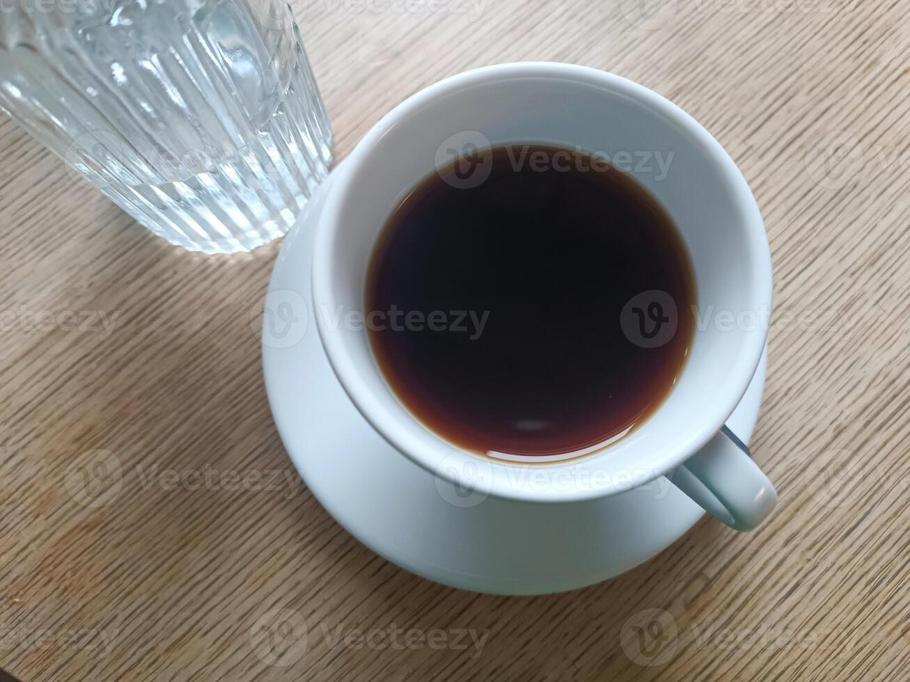 Top view white cup black coffee with water bottle wooden table. Morning routine coffee breakfast photo