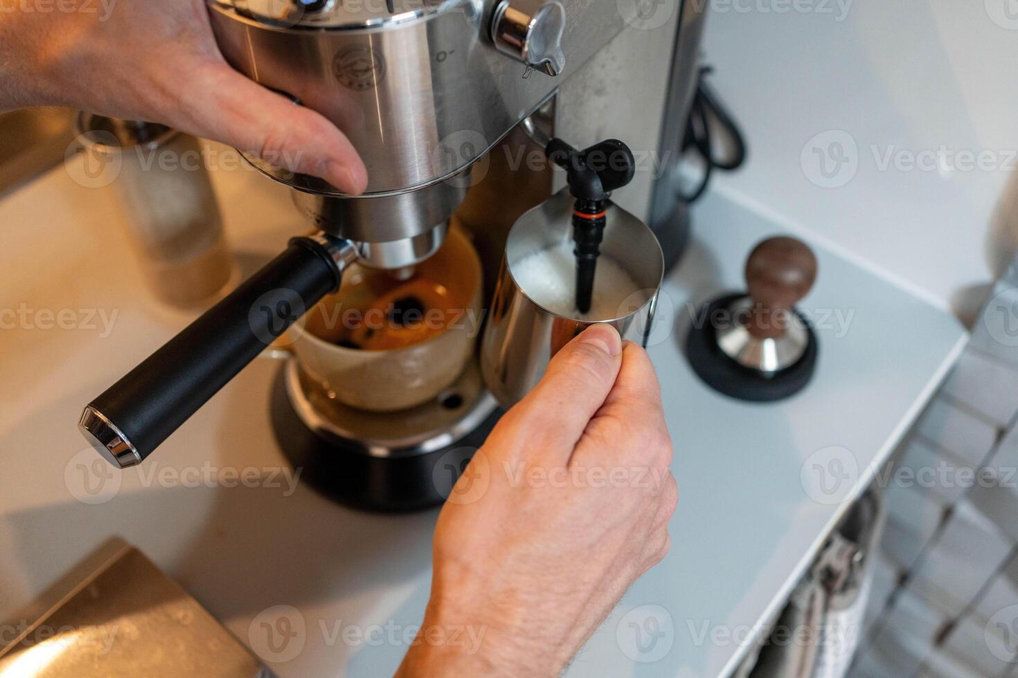 Close-up of hands frothing milk photo