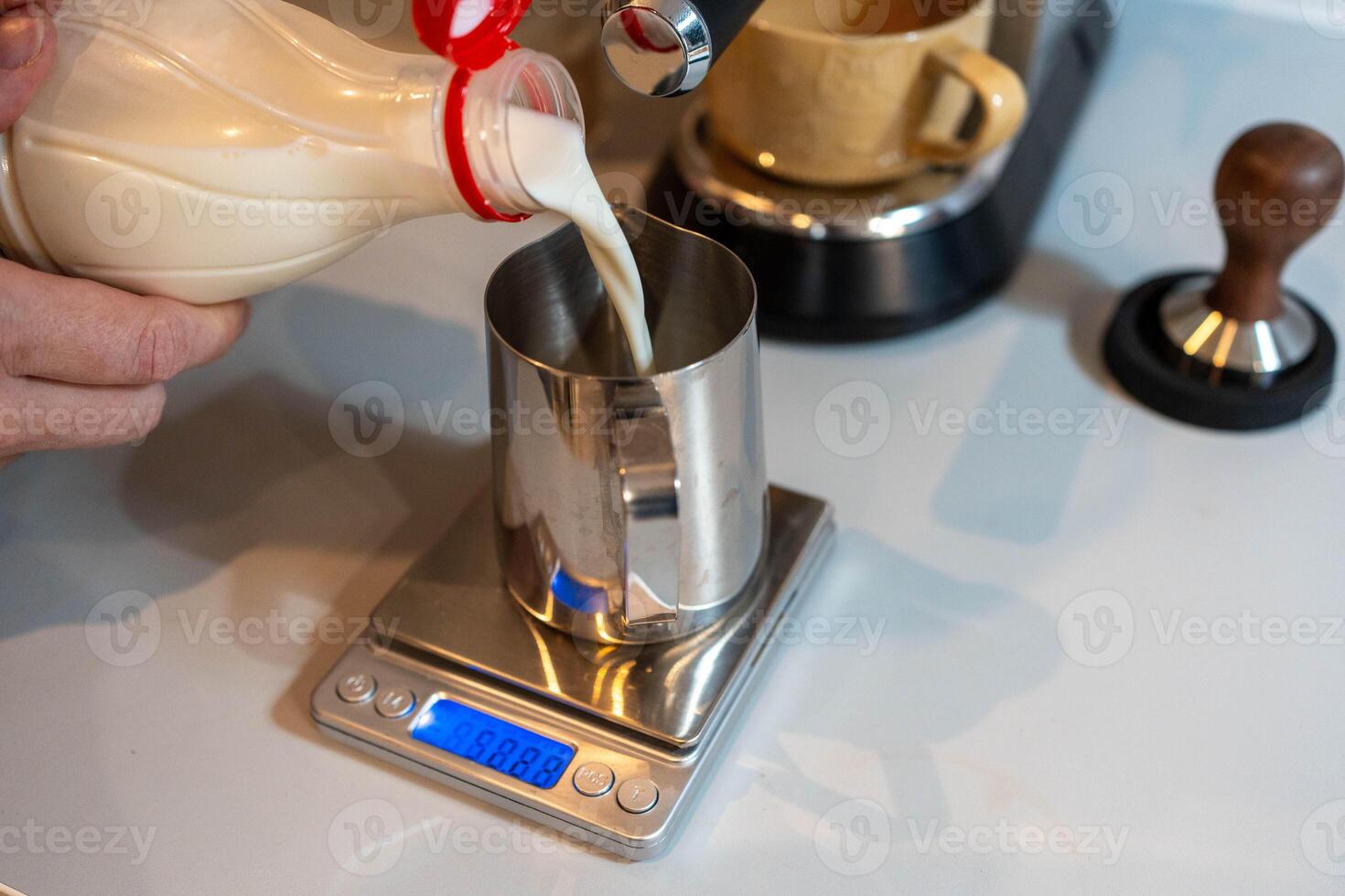 Preparation of milk for cappuccino photo