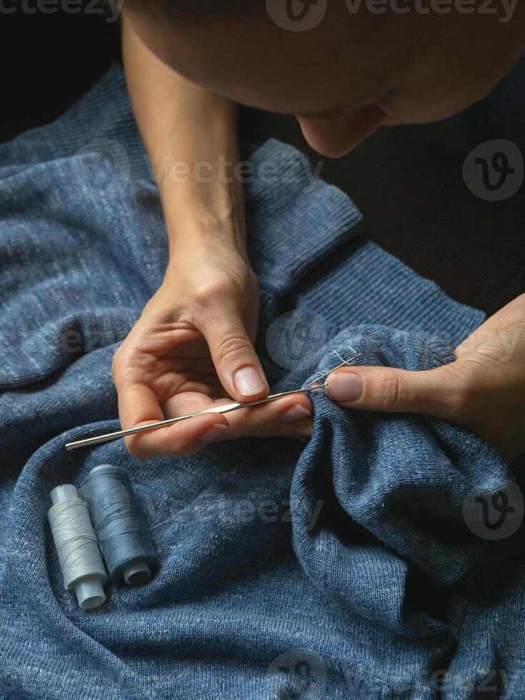hole in the clothing. Crocheted clothing restoration. photo