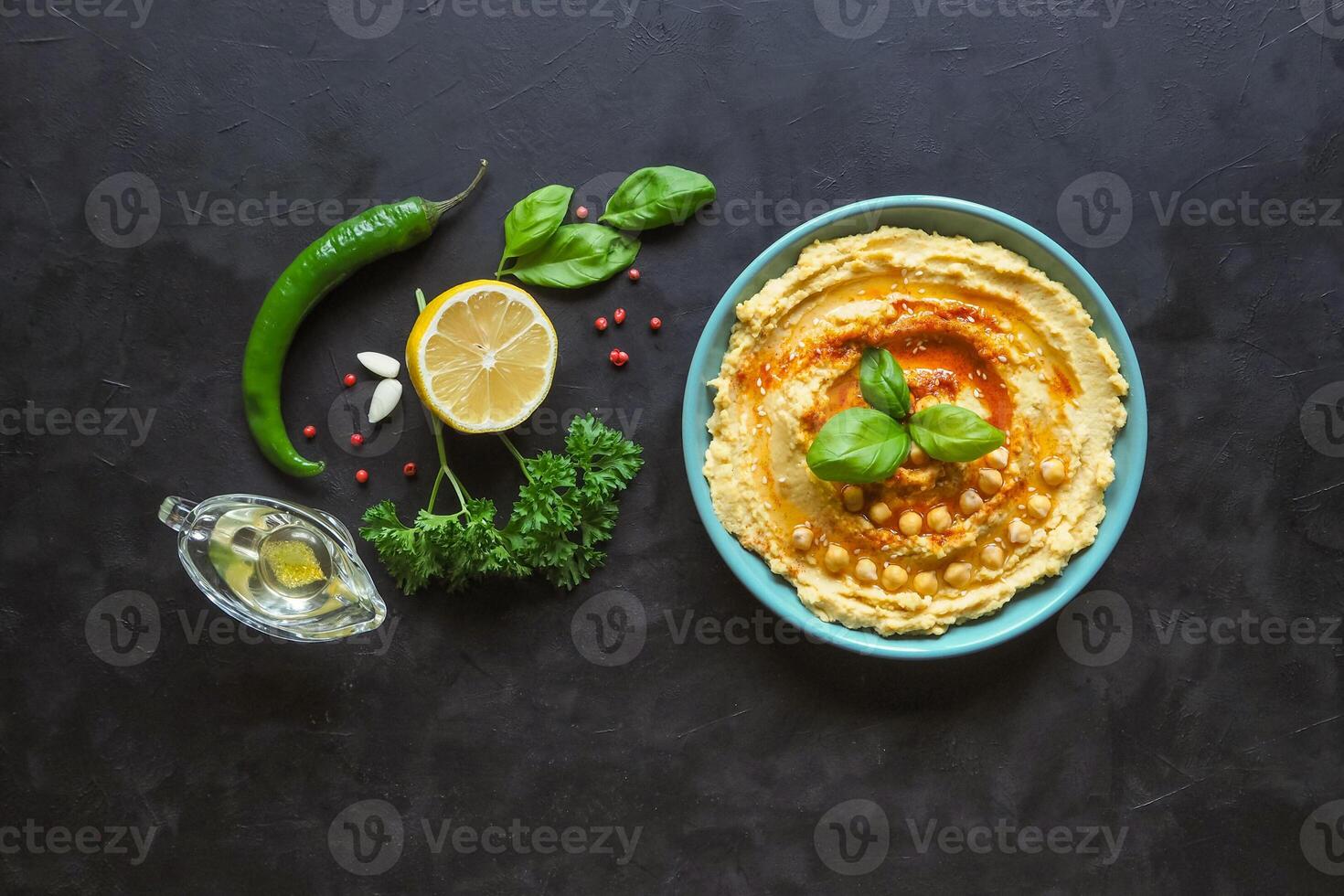 Traditional hummus on a black kitchen table, top view photo