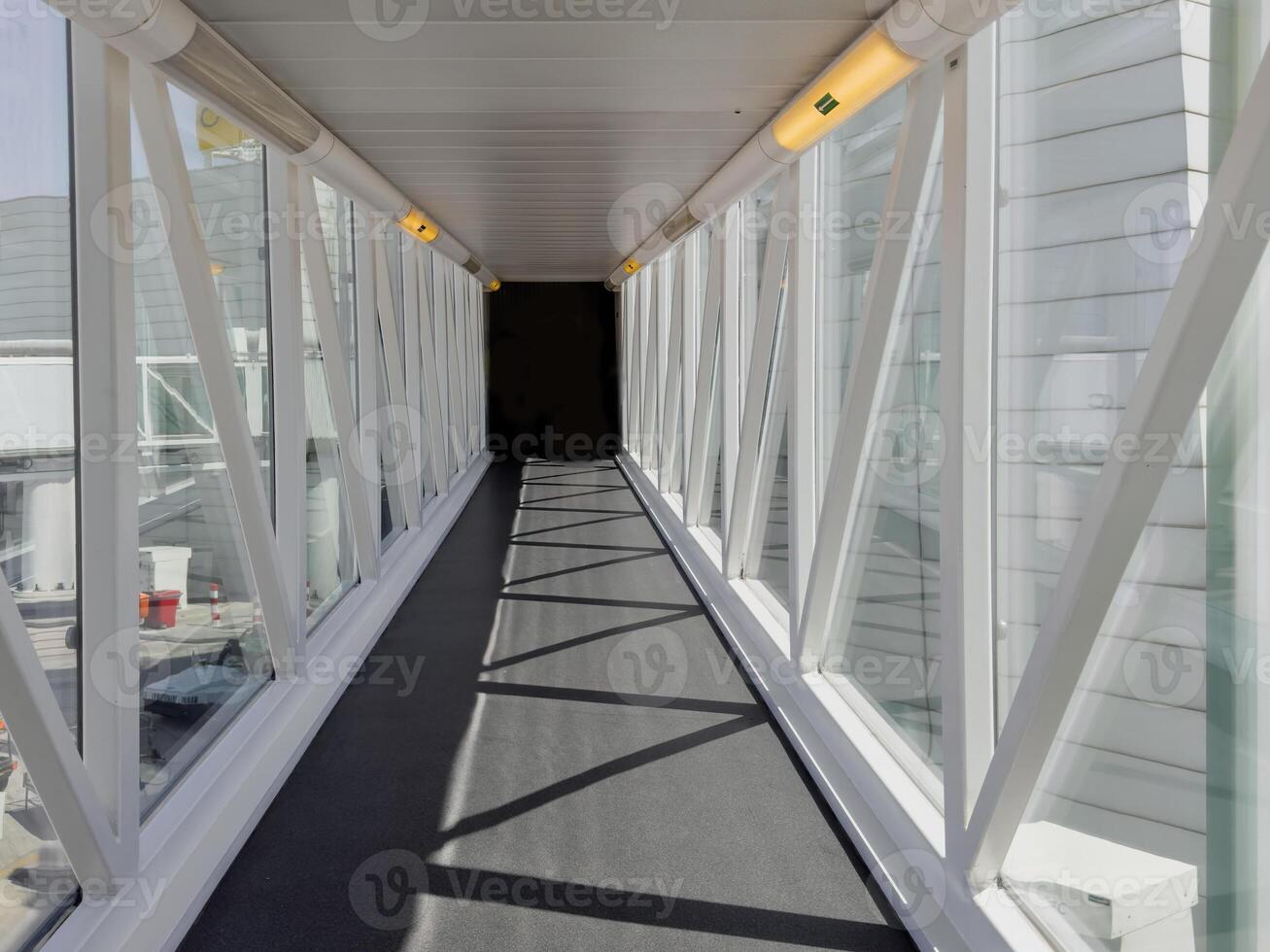 Bridge corridor walkway in airport with morning sunlight. photo