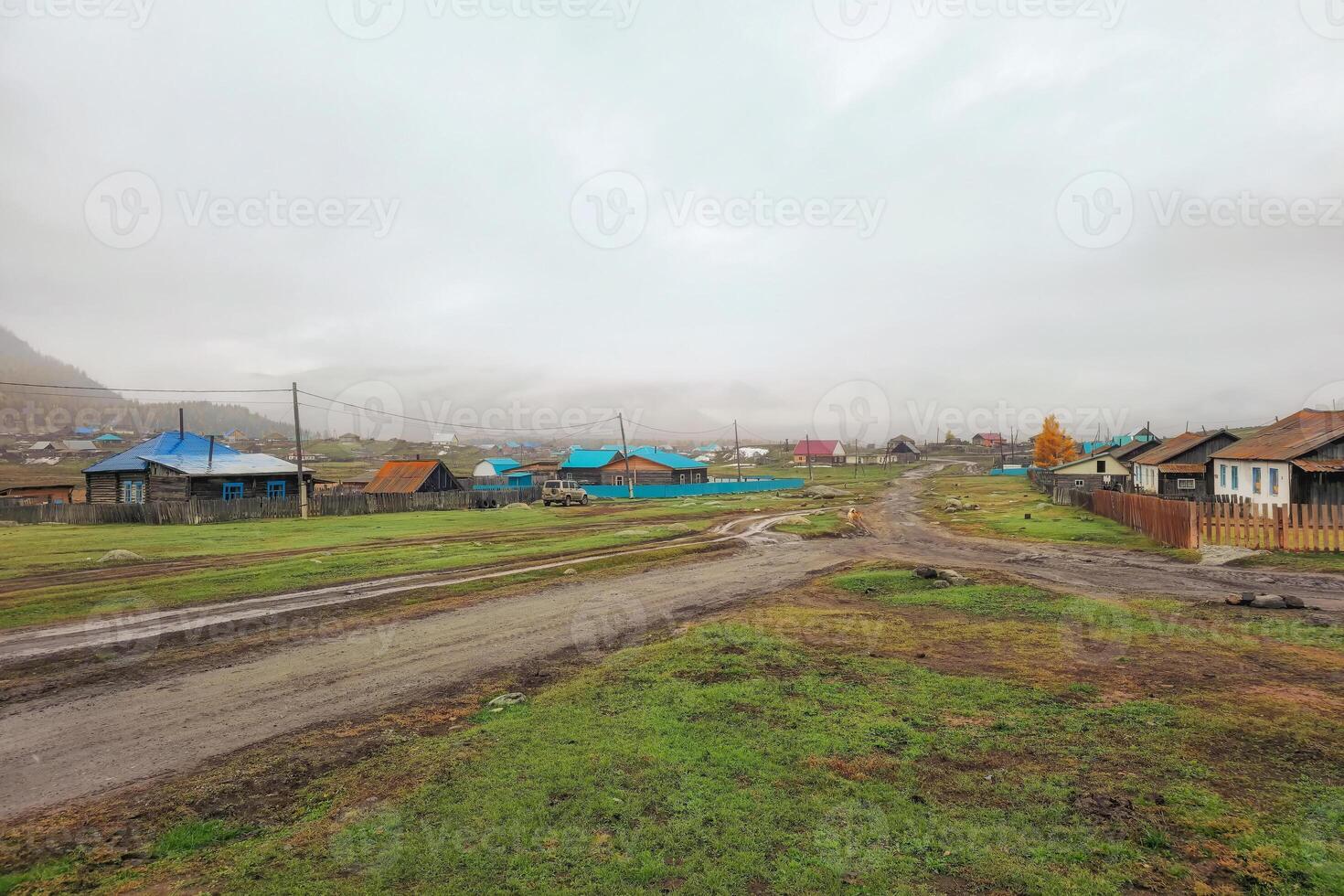 Real rural life in a remote area of Altai. Rural road washed out by rain photo