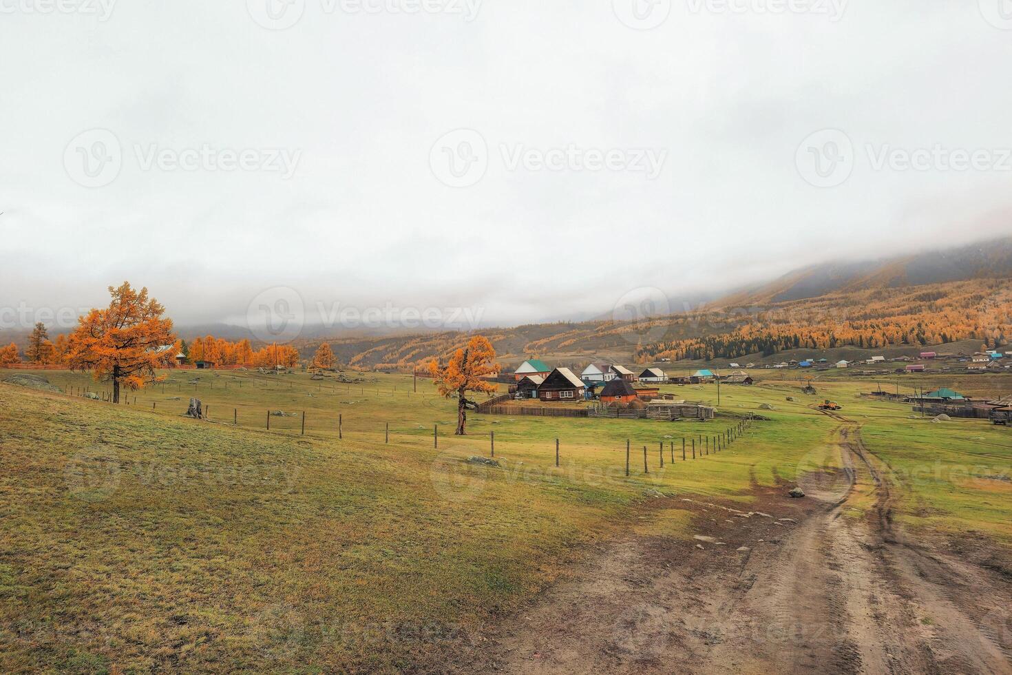 Autumn dirt road from a hill to a remote village. Off-road in village photo