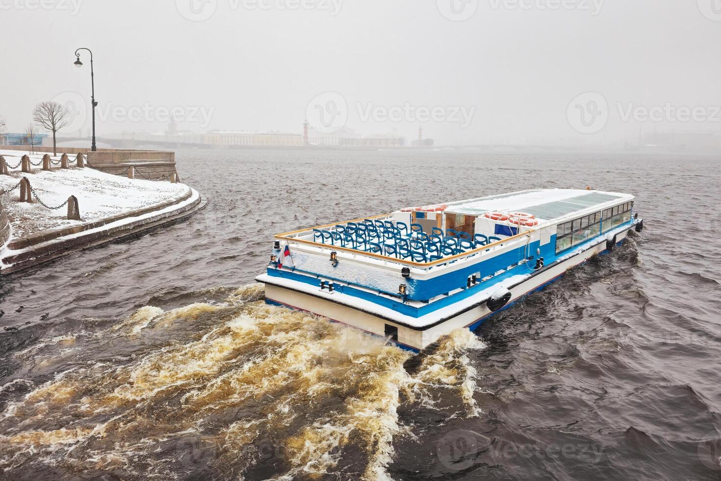 boat on the Neva river in a spring snowstorm. St. Petersburg. photo