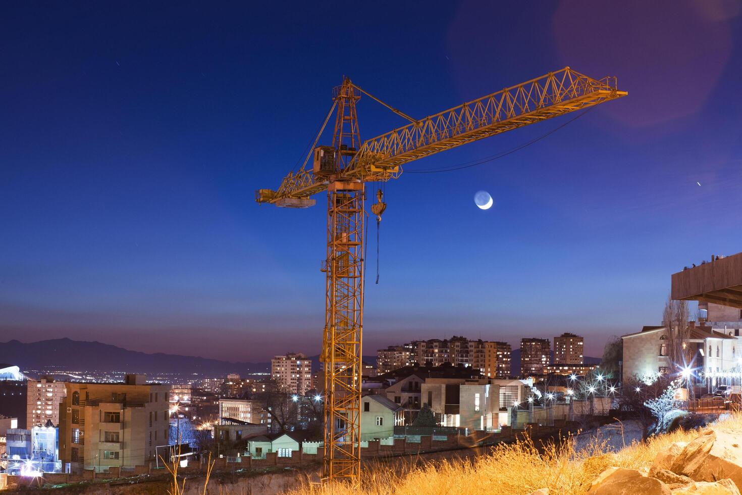 Construction site at night in light city photo