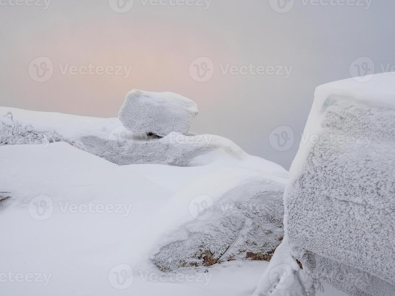 Balancing stone in winter. Falling large boulder photo