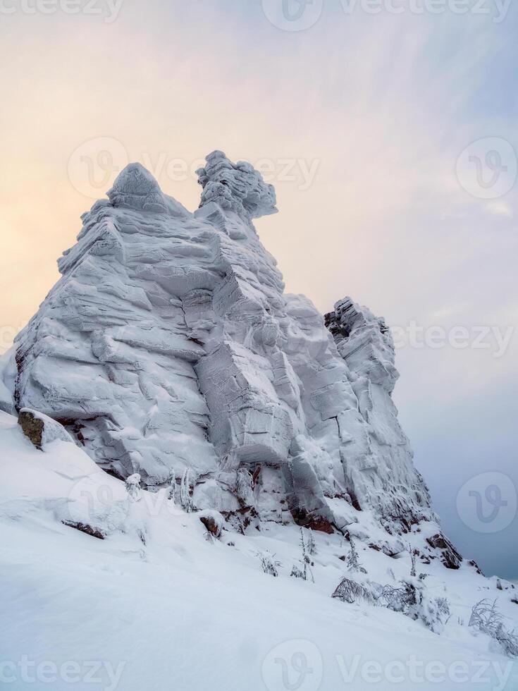 Big snow rock is frozen and covered with snow photo