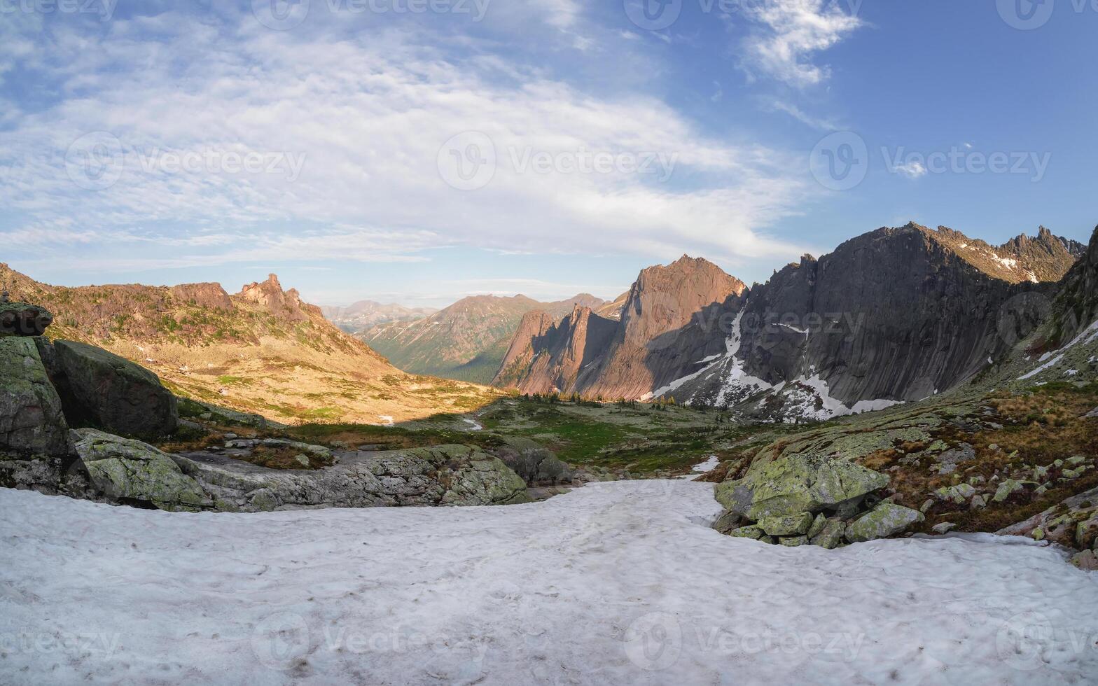 Snowy sunny stony pass, large colorful mountain range photo