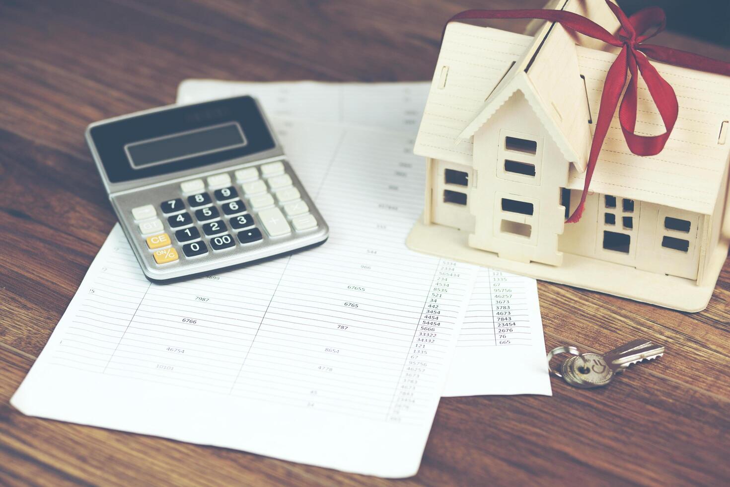 house model with calculator and key on documents photo