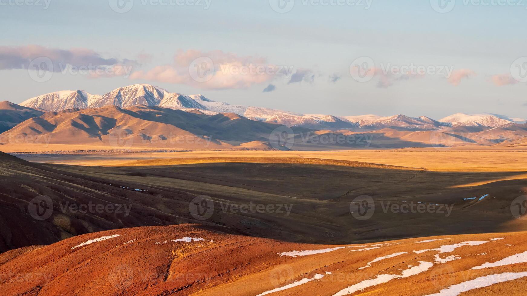 Autumn snow mountains at sunset. Bright panoramic mountain landscape photo