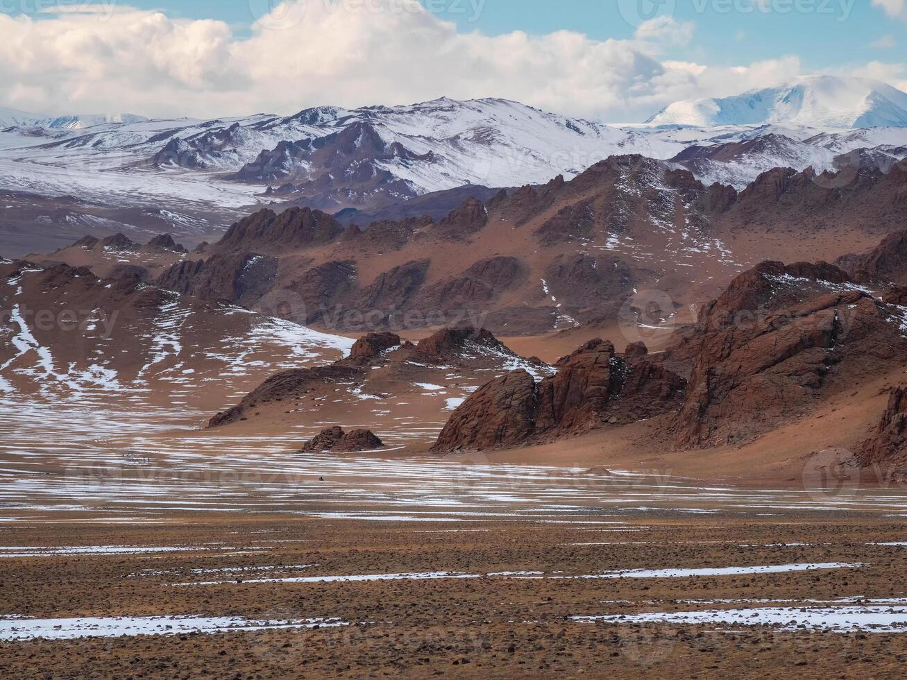 Texture of snow-capped mountains. Minimalist nature background of snowy mountainside. Misty mountain minimalism of snowbound mountain in cloudy day. Mongolia. photo