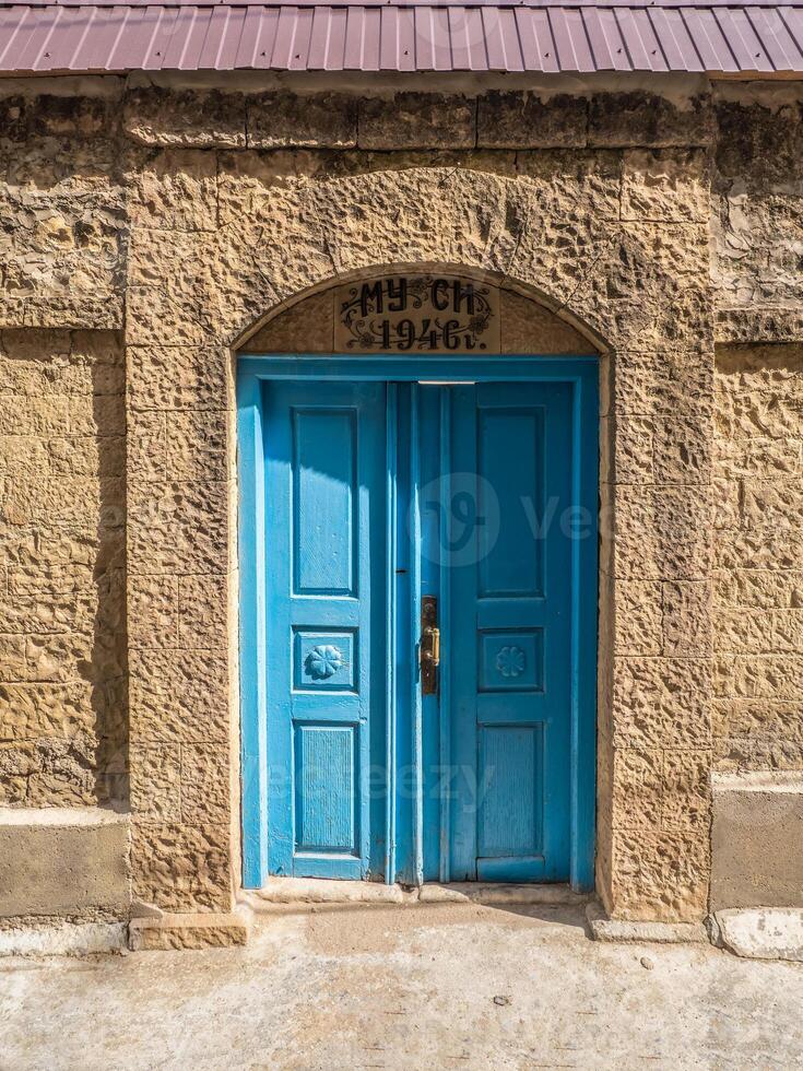 Vintage blue wooden door in a mountain authentic village photo