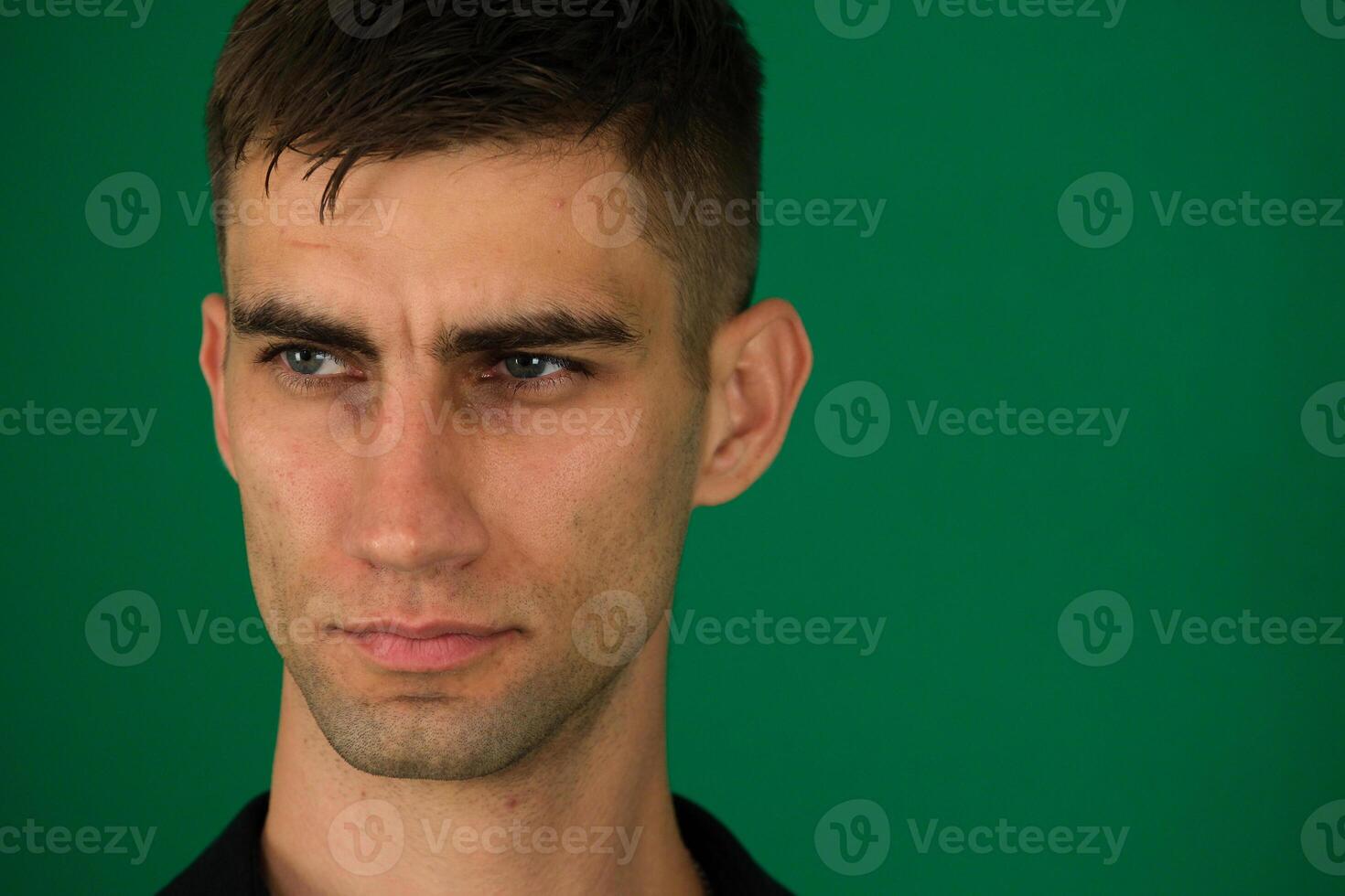 Young mistaken worried sad caucasian man 20s wear casual orange t-shirt look aside scratch hold head isolated on plain pastel light green color background studio portrait. People lifestyle concept. photo