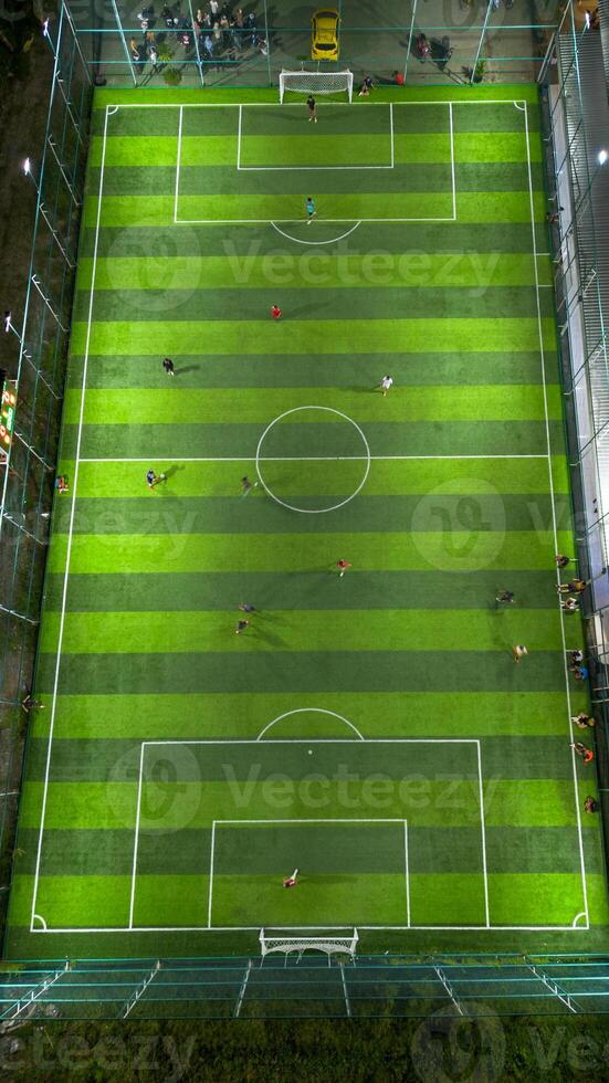 Soccer field with players in the match. Aerial view of soccer field in football stadium photo