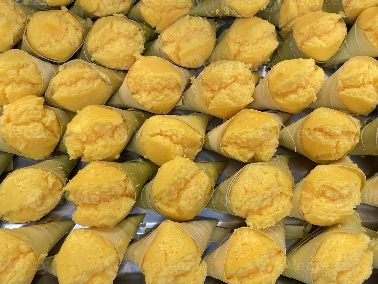 Top view of Toddy Palm Cake is a traditional Thai dessert. The dessert's texture is dark yellow, soft, fluffy, and has a sweet sugary aroma. Made from ripe palm fruit flesh. photo