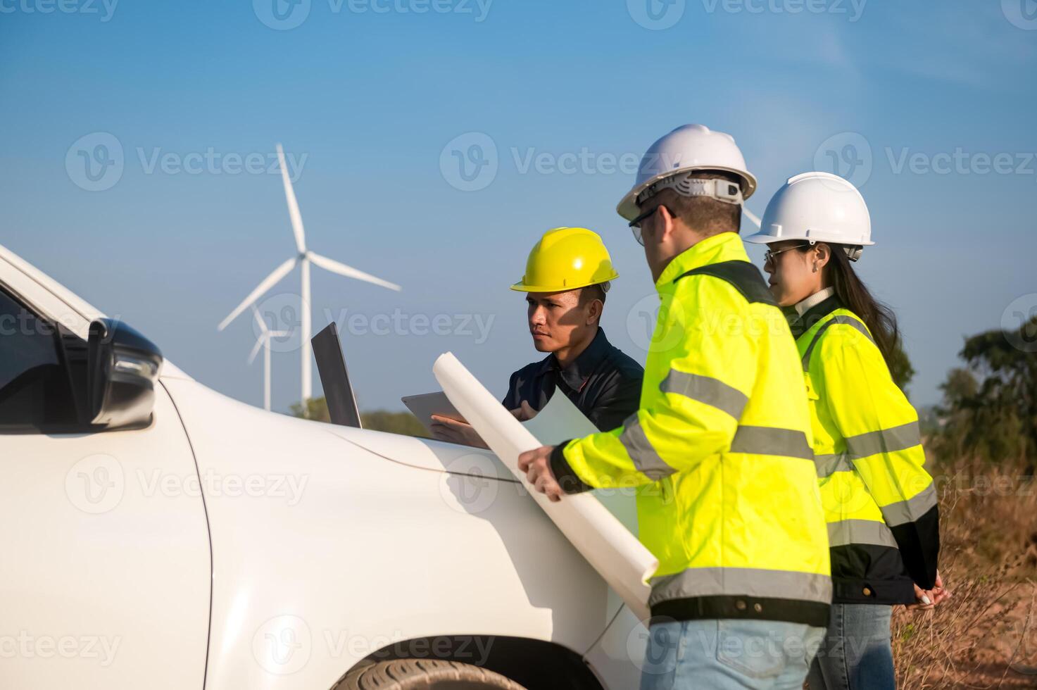Engineers brainstorm on a plan to inspect the performance of wind turbines in the field. photo