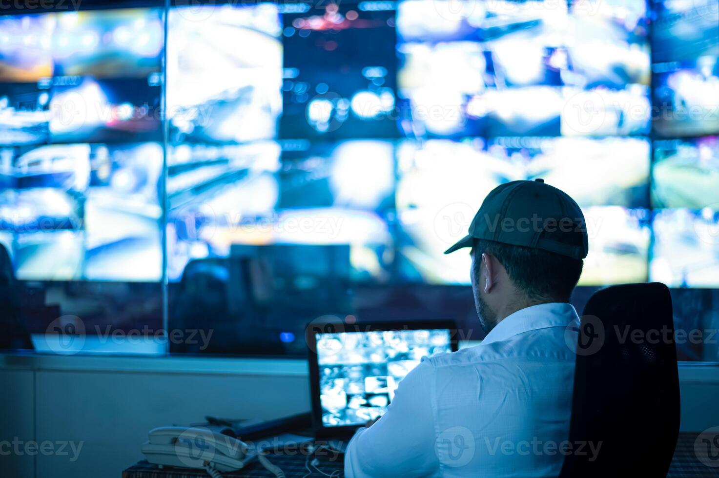 Security guards are monitoring multiple CCTV monitors and reporting on events that occur.. photo