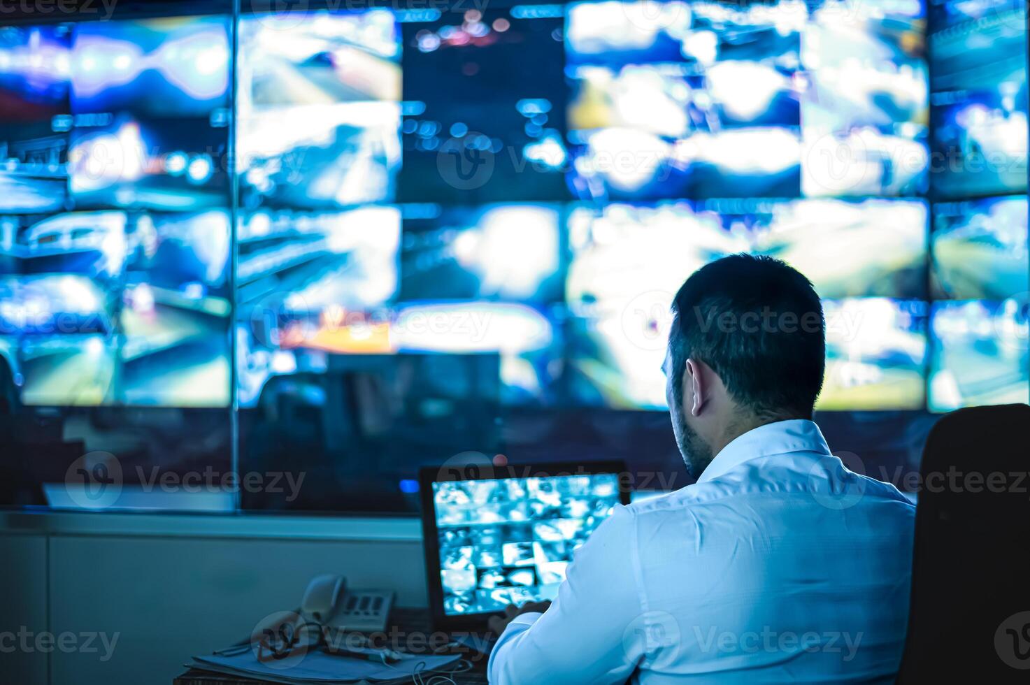 Security guards are monitoring multiple CCTV monitors. photo