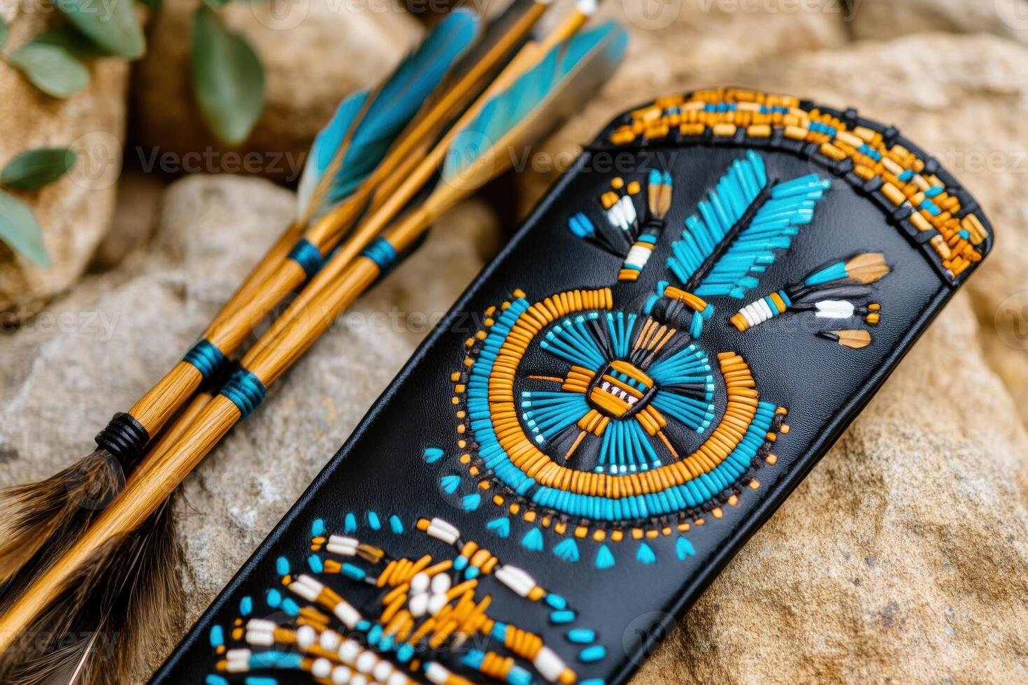 Traditional Native American bow and quiver with intricate beadwork and feathers arranged on a natural stone background photo