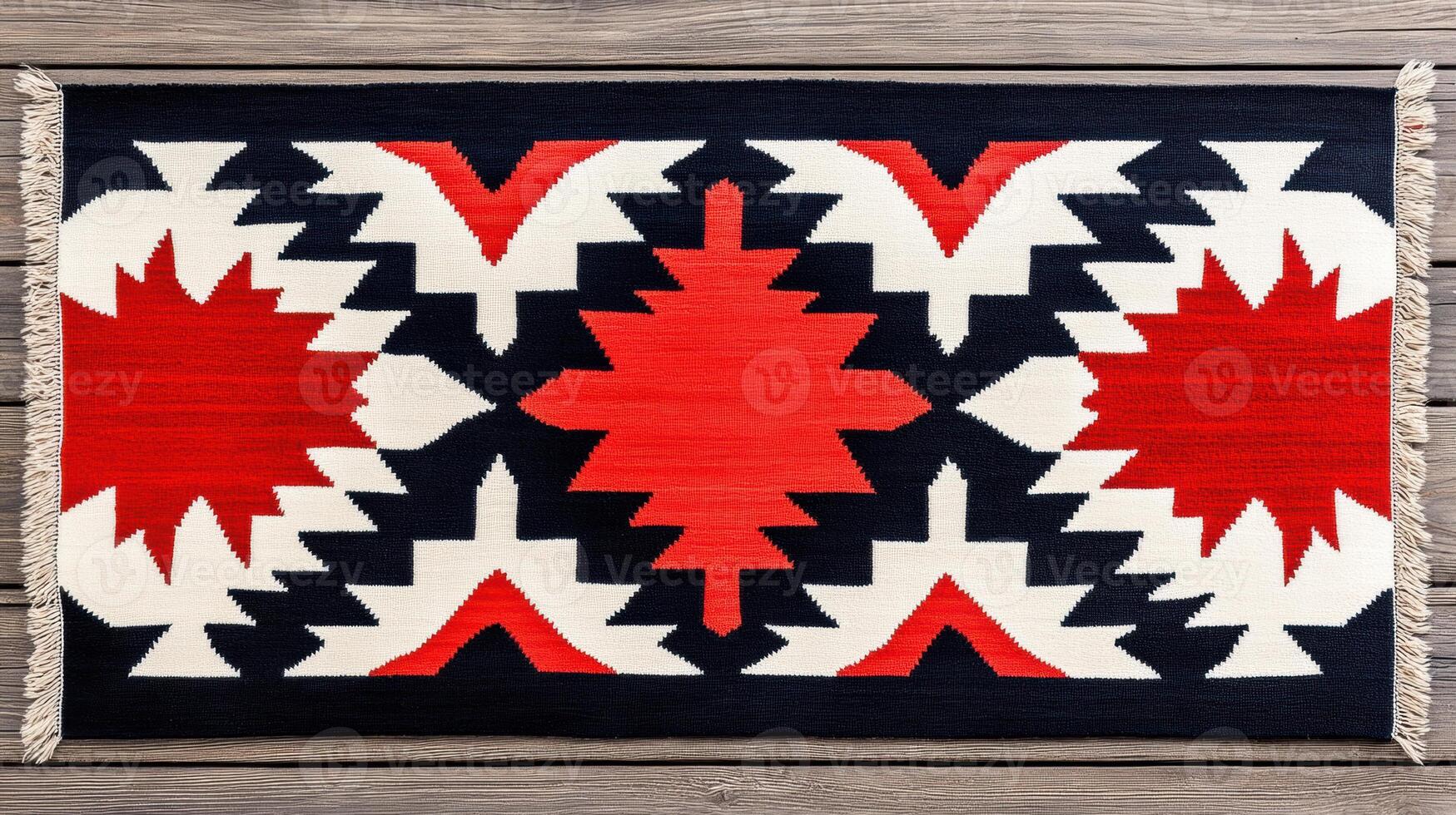 Handwoven Native American rug with intricate patterns in red, black, and white on rustic wooden floor photo