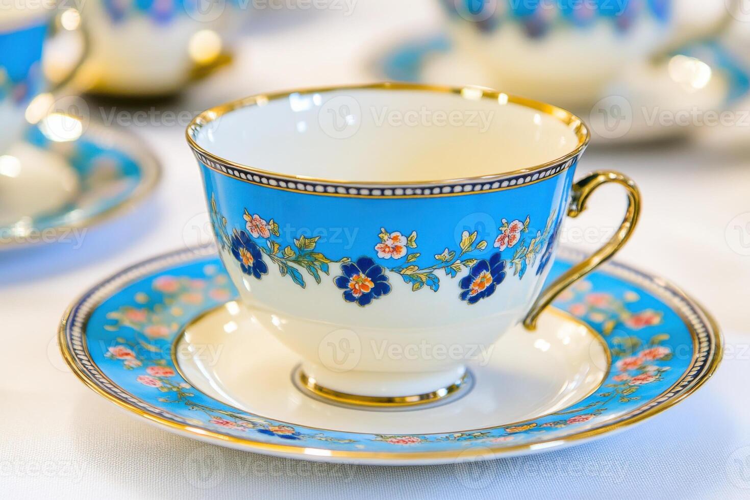Elegant porcelain tableware in blue and light blue with floral patterns arranged gracefully on a white tablecloth photo