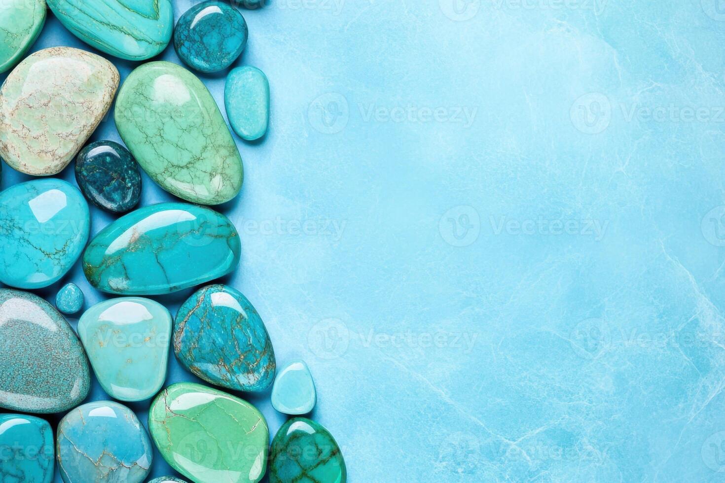 Polished turquoise gemstones arranged artistically on a soft blue background showcasing deep turquoise and aquamarine colors photo